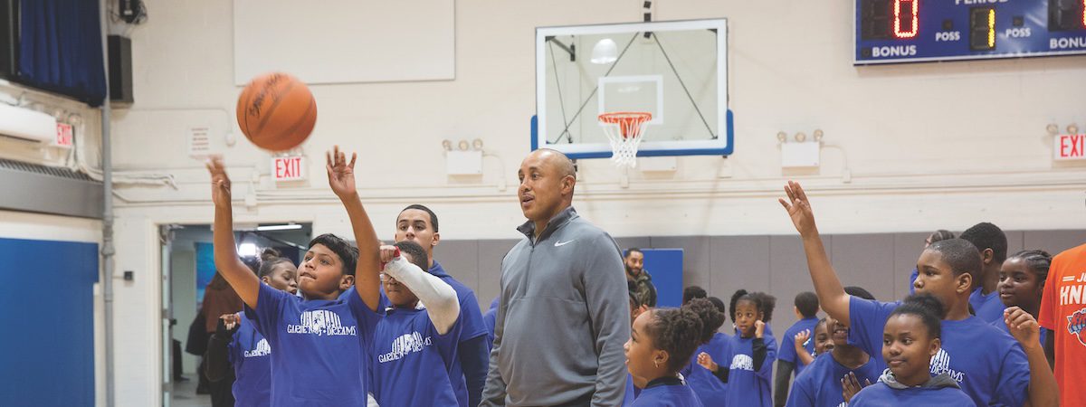 kids playing basketball with coach