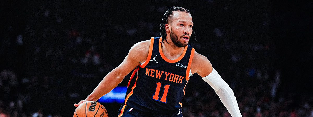 Jalen Brunson dribbles in navy Knicks statement jersey